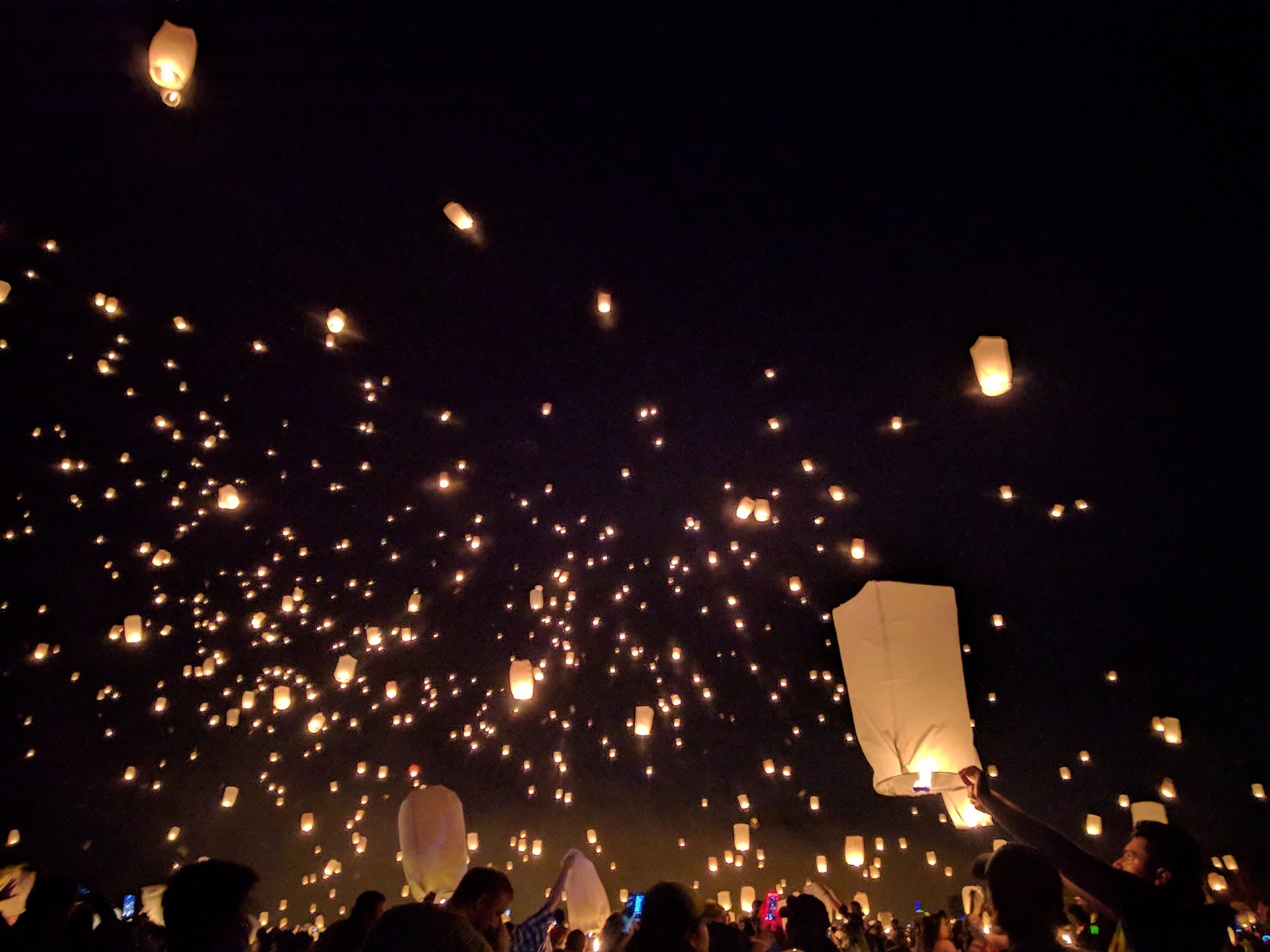 Lanterns rising into a night sky